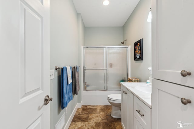 full bathroom featuring toilet, vanity, and shower / bath combination with glass door