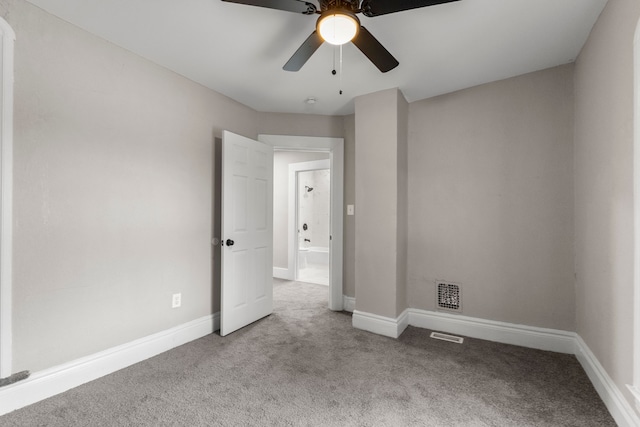 unfurnished room featuring light colored carpet and ceiling fan