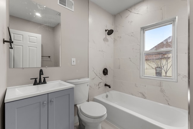 full bathroom featuring tiled shower / bath combo, vanity, and toilet