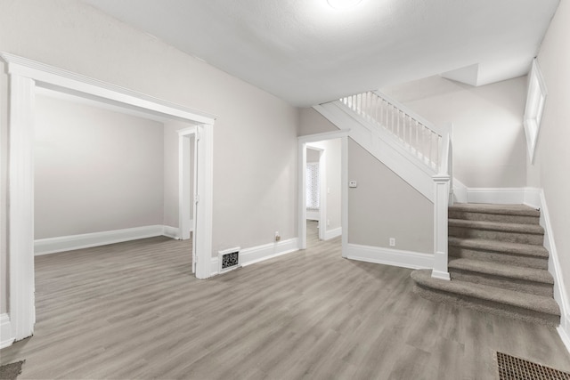 unfurnished living room with wood-type flooring