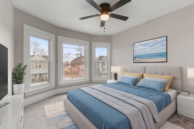 bedroom featuring light colored carpet and ceiling fan