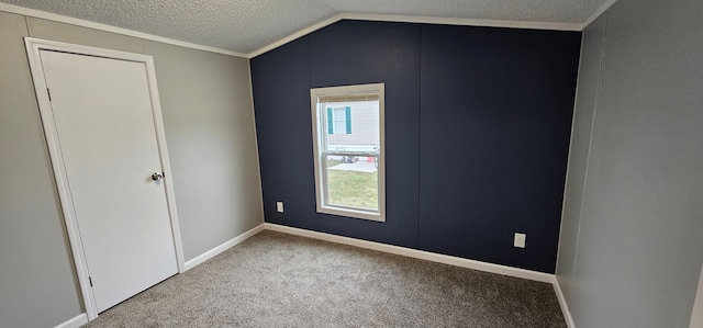 unfurnished room with lofted ceiling, carpet, and a textured ceiling