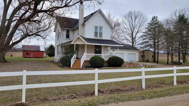 view of front of property featuring a porch and a garage