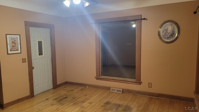 unfurnished room with ceiling fan and light hardwood / wood-style flooring