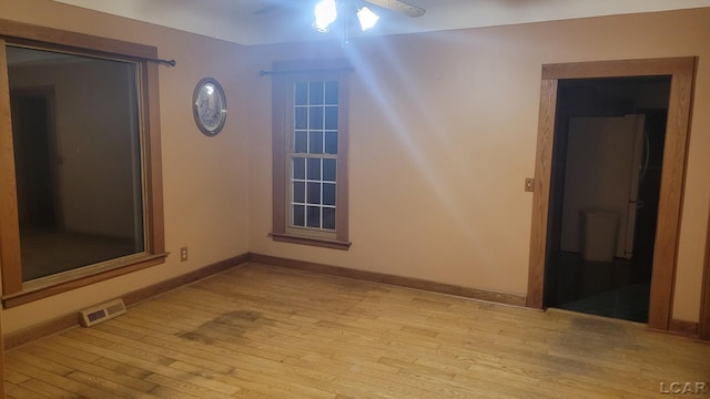 empty room with light hardwood / wood-style floors and ceiling fan