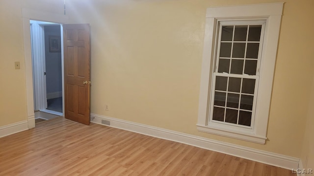 spare room featuring light wood-type flooring