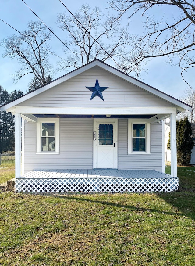 view of front of home featuring a front yard and a porch