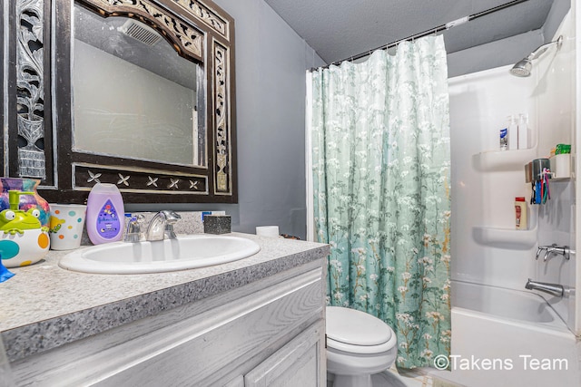 full bathroom featuring vanity, shower / tub combo, a textured ceiling, and toilet