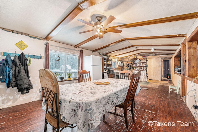 dining space with vaulted ceiling with beams, dark wood-type flooring, a textured ceiling, and ceiling fan