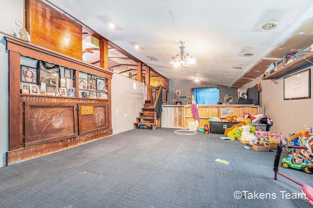 interior space featuring vaulted ceiling, carpet floors, and a notable chandelier