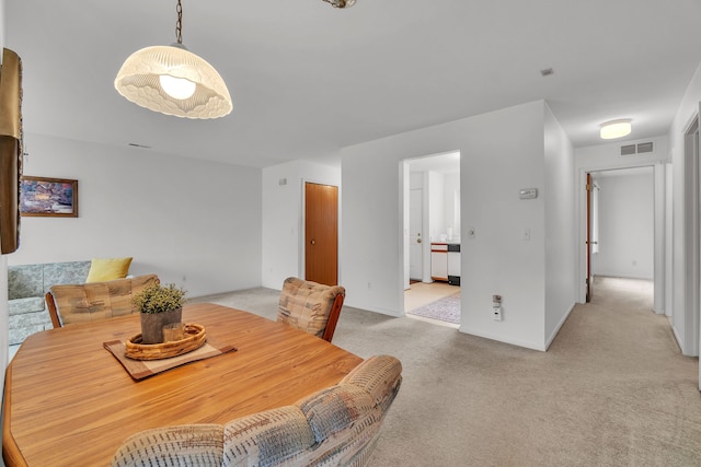 dining space with light carpet