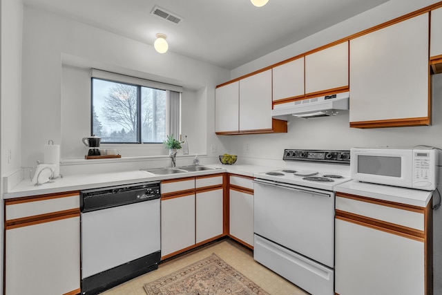 kitchen with white cabinetry, white appliances, and sink