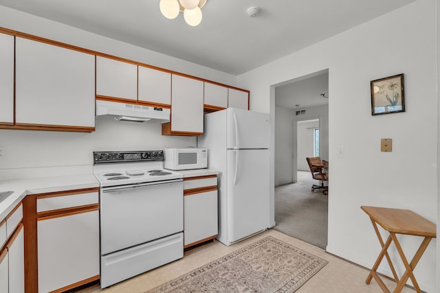 kitchen featuring white appliances and white cabinets