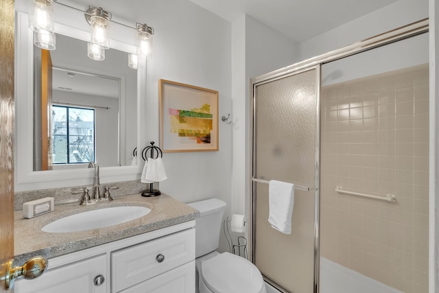 bathroom with vanity, toilet, and an enclosed shower