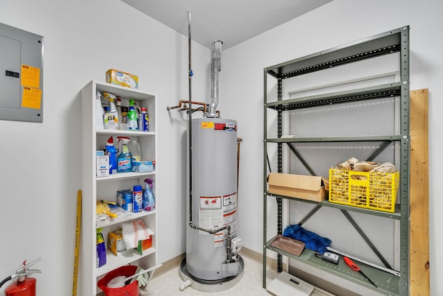 utility room featuring gas water heater and electric panel