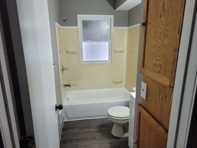 bathroom with wood-type flooring,  shower combination, and toilet