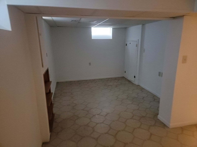 basement featuring a paneled ceiling