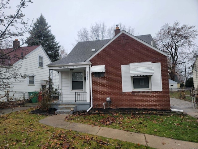 bungalow-style house featuring a front yard