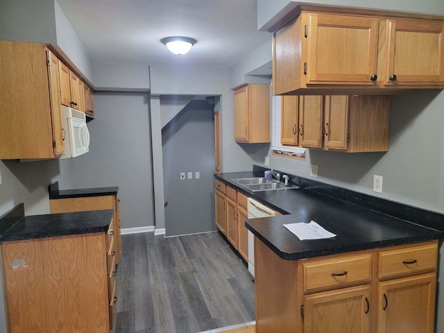 kitchen featuring dark hardwood / wood-style floors, sink, and white appliances