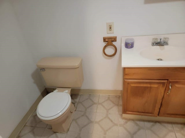 bathroom featuring vanity, toilet, and tile patterned flooring