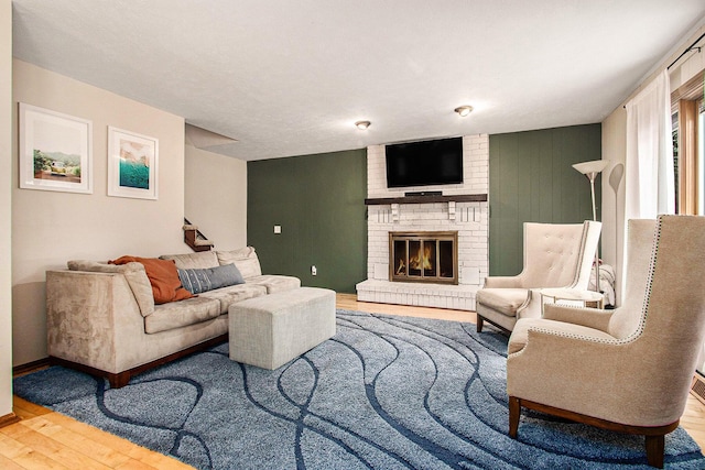 living room with hardwood / wood-style flooring and a fireplace