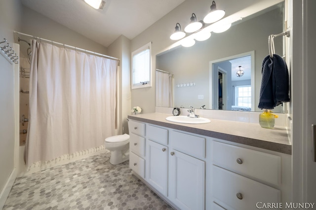 full bathroom with lofted ceiling, vanity, toilet, and plenty of natural light