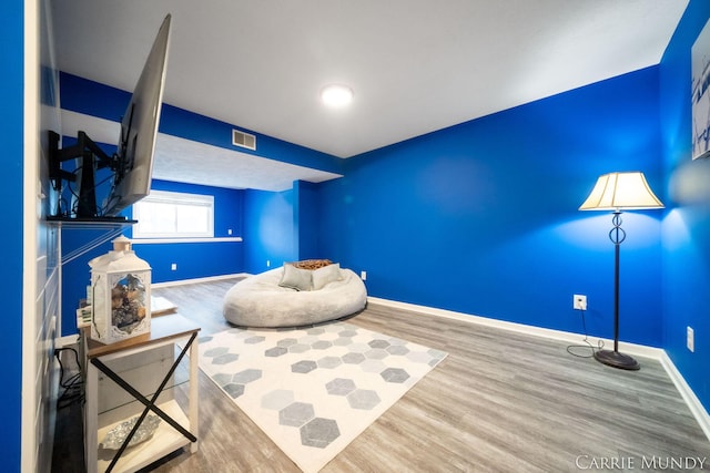 sitting room with hardwood / wood-style flooring