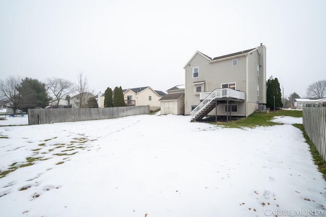 snow covered house featuring a deck