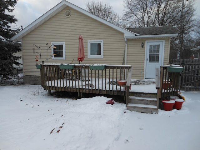 snow covered property featuring a wooden deck