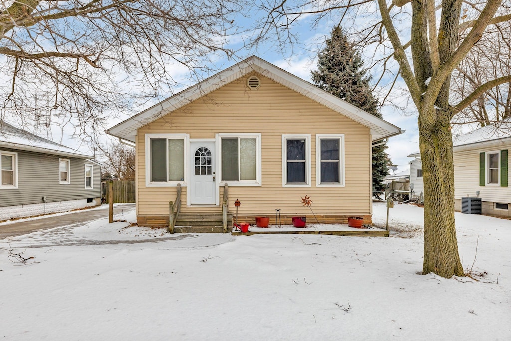 bungalow-style home with cooling unit