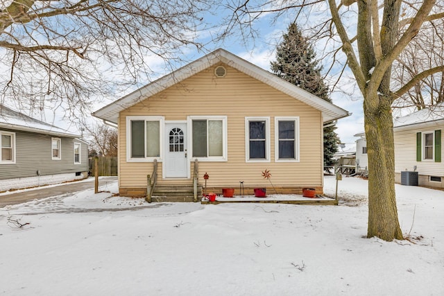 bungalow-style home with cooling unit