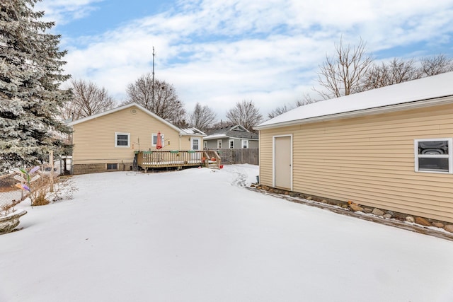 yard covered in snow featuring a deck