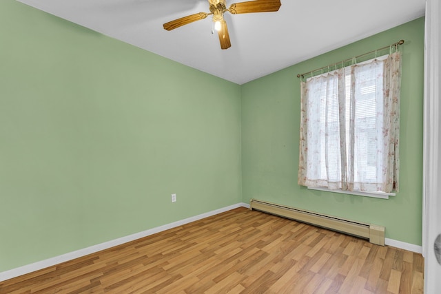 unfurnished room featuring a healthy amount of sunlight, a baseboard heating unit, ceiling fan, and light hardwood / wood-style floors