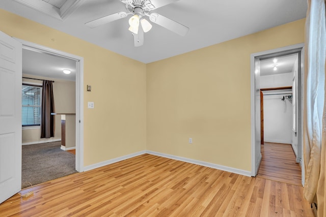 unfurnished bedroom with ceiling fan and light wood-type flooring