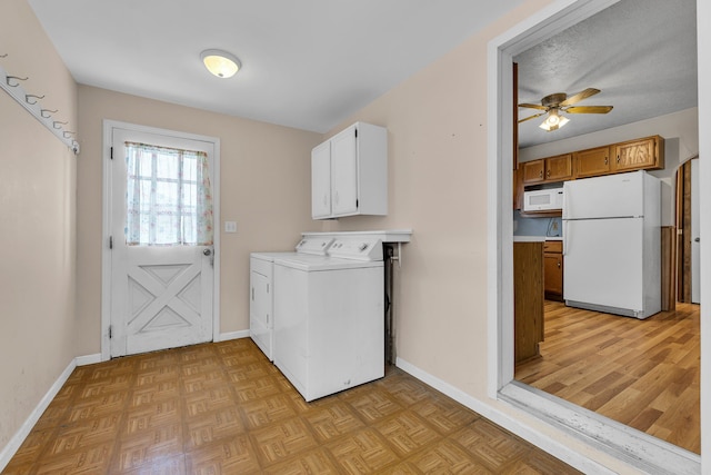 washroom with ceiling fan, cabinets, washing machine and dryer, and light parquet floors