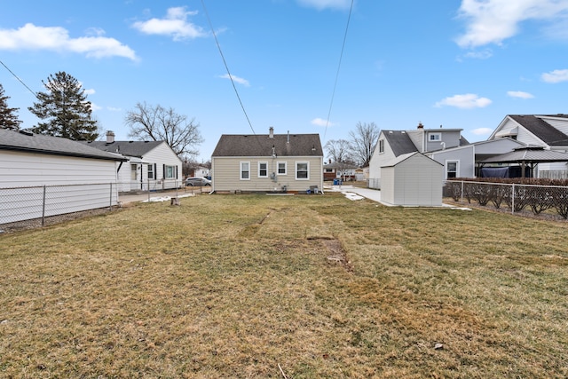 back of house with a storage unit and a lawn