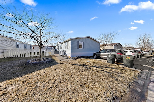 view of side of home with a yard