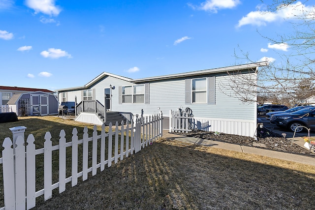 view of front of home with a storage shed