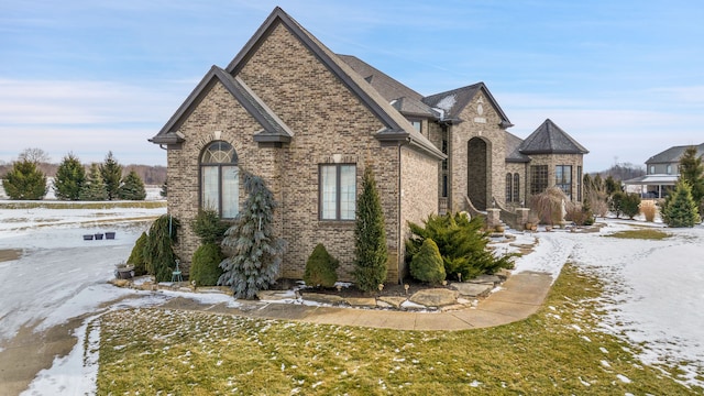 snow covered property with a yard