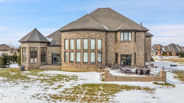 view of snow covered rear of property