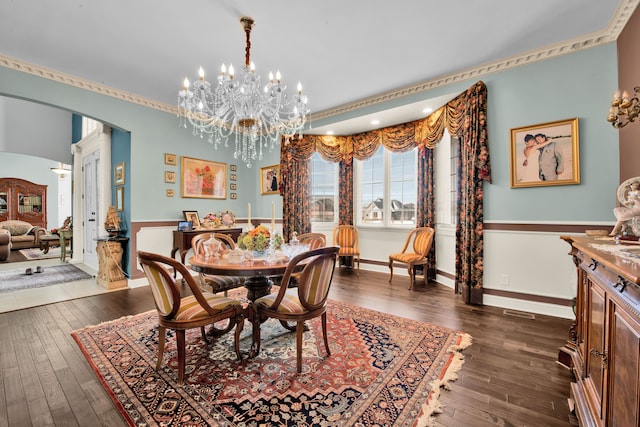 dining space featuring dark hardwood / wood-style flooring and a notable chandelier