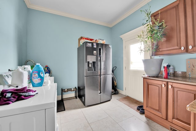 kitchen featuring crown molding, stainless steel fridge, and light tile patterned flooring