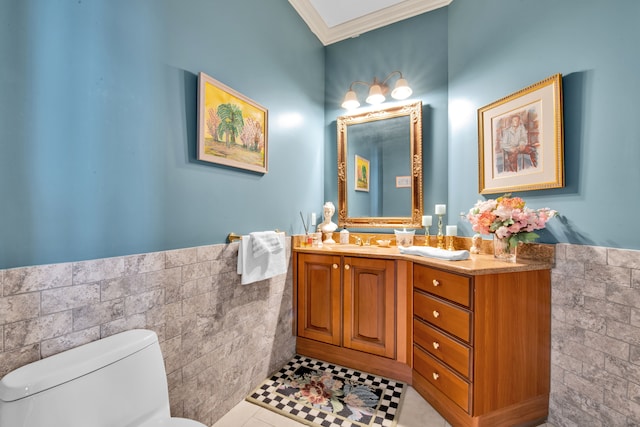 bathroom featuring crown molding, tile walls, vanity, tile patterned floors, and toilet