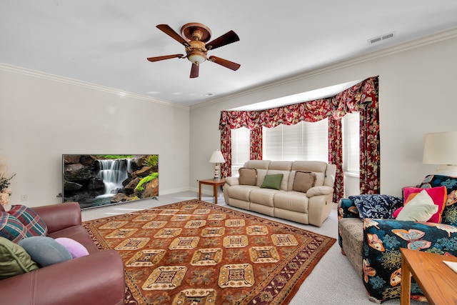 carpeted living room with ornamental molding and ceiling fan