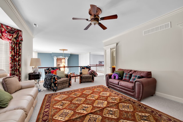 carpeted living room featuring ornamental molding and ceiling fan