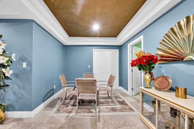 dining space featuring a raised ceiling