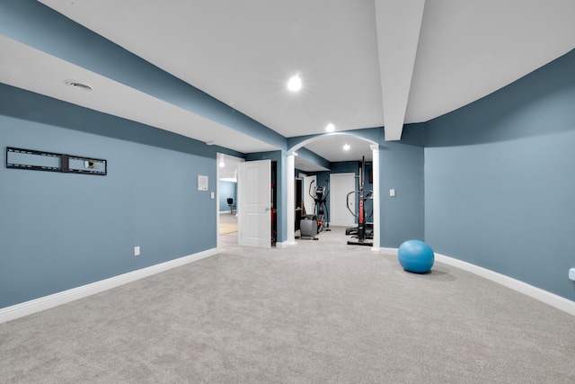 exercise room featuring light colored carpet