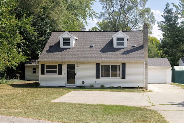 cape cod-style house with an outbuilding, a garage, and a front yard