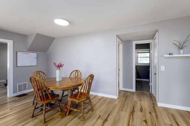 dining area with light hardwood / wood-style floors