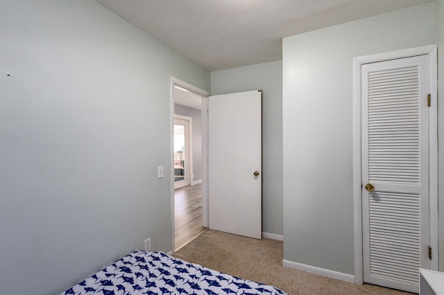 carpeted bedroom with a textured ceiling